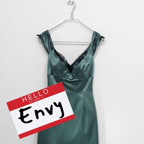 pun halloween costume with green dress and name tag that says hello, my name is envy