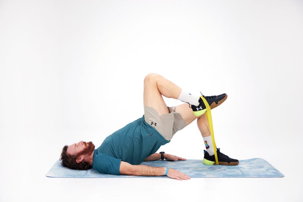 a man lying on his back on a mat
