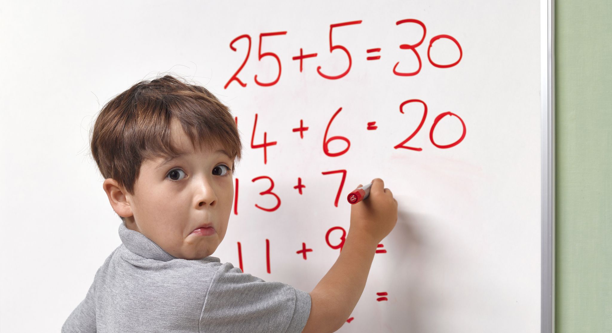 pupil baffled by maths sum on classroom whiteboard