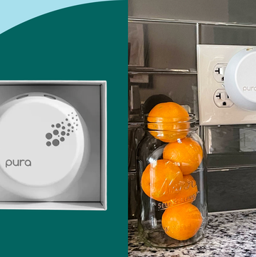 pura diffuser in kitchen outlet next to stack of oranges and cooking utensils