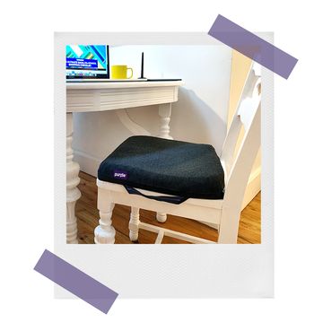 purple royal cushion on wooden chair at kitchen table