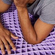 person resting on purple mattress