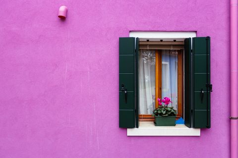 purple window and facade of a vibrant colorful house