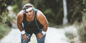 purposeful fat man running in park, out of breath, persistent motivation