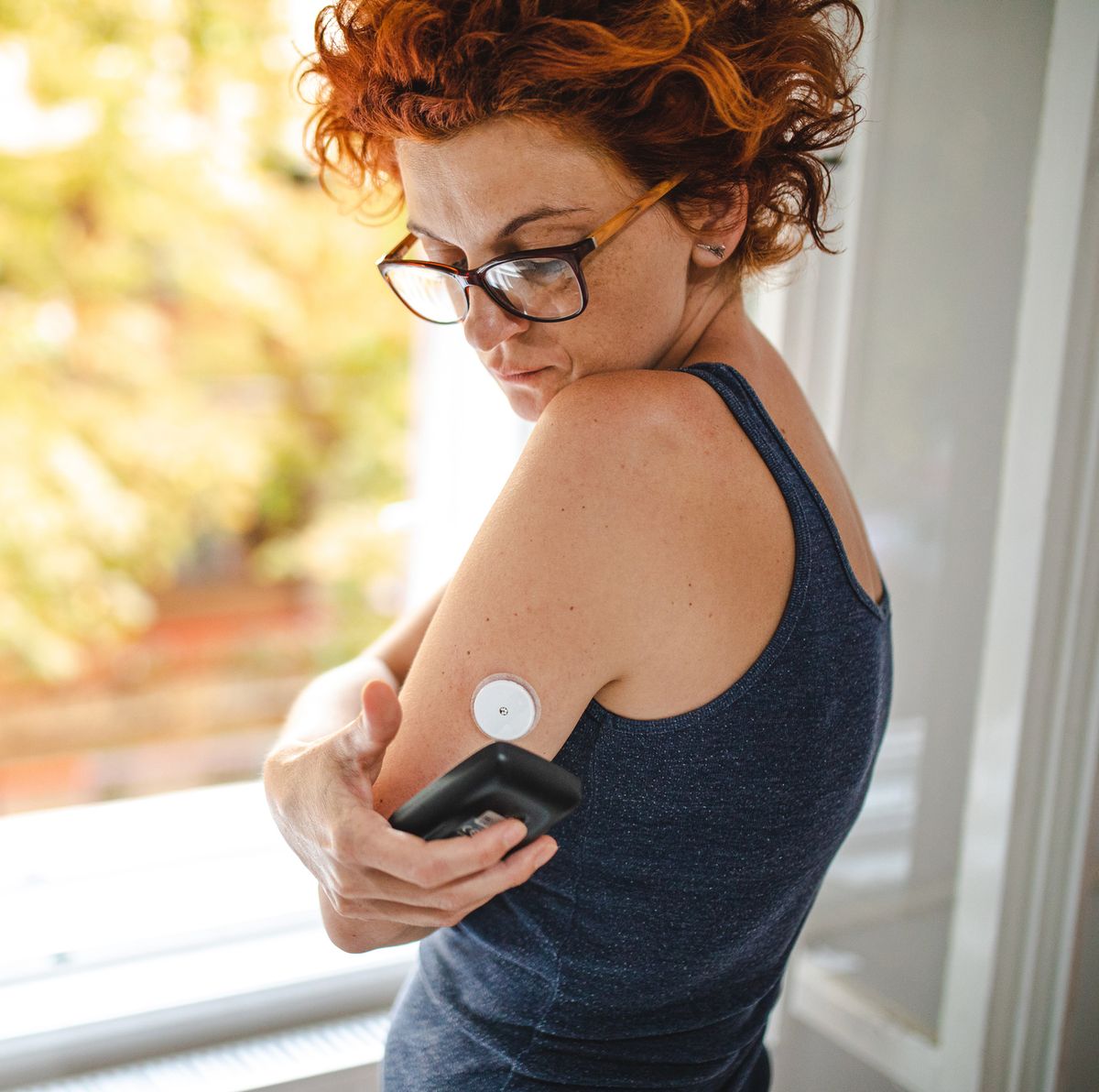 putting reader device over it to see the current blood sugar level