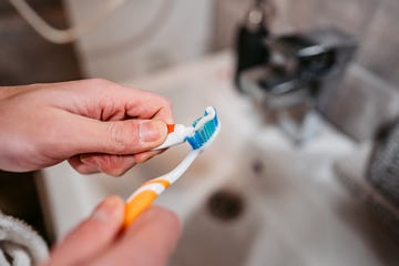 putting the toothpaste on a toothbrush