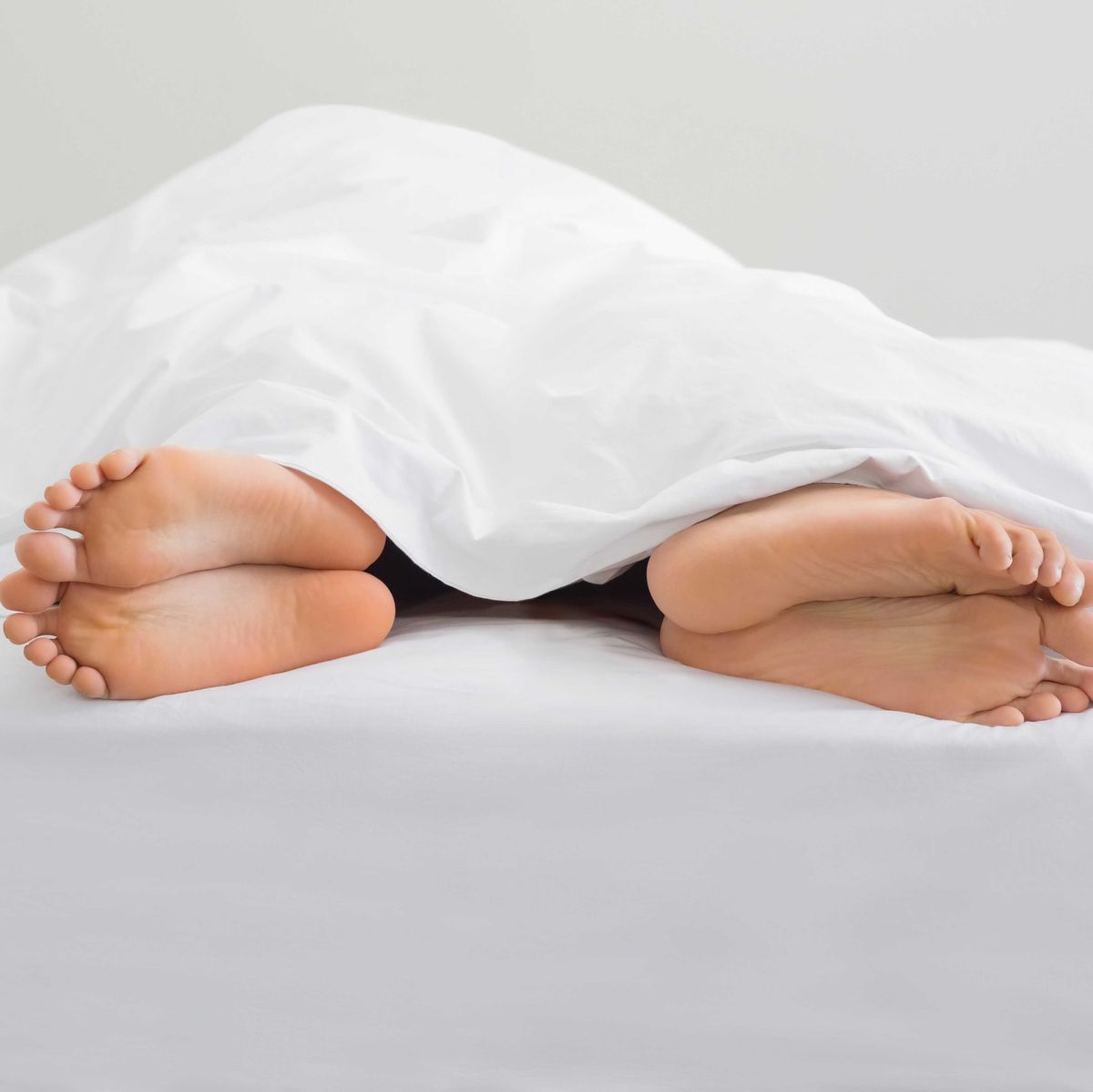 two bare feet sticking out from bottom of comforter sex sexual health