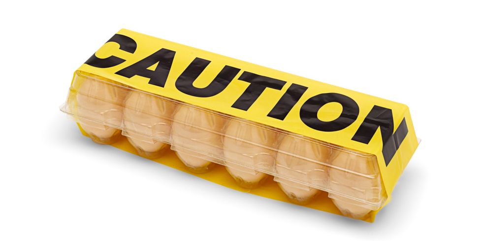 carton of eggs with caution tape on top food allergies
