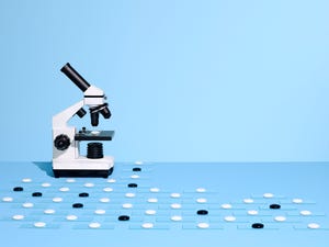 microscope with more white slides to look at than black slides