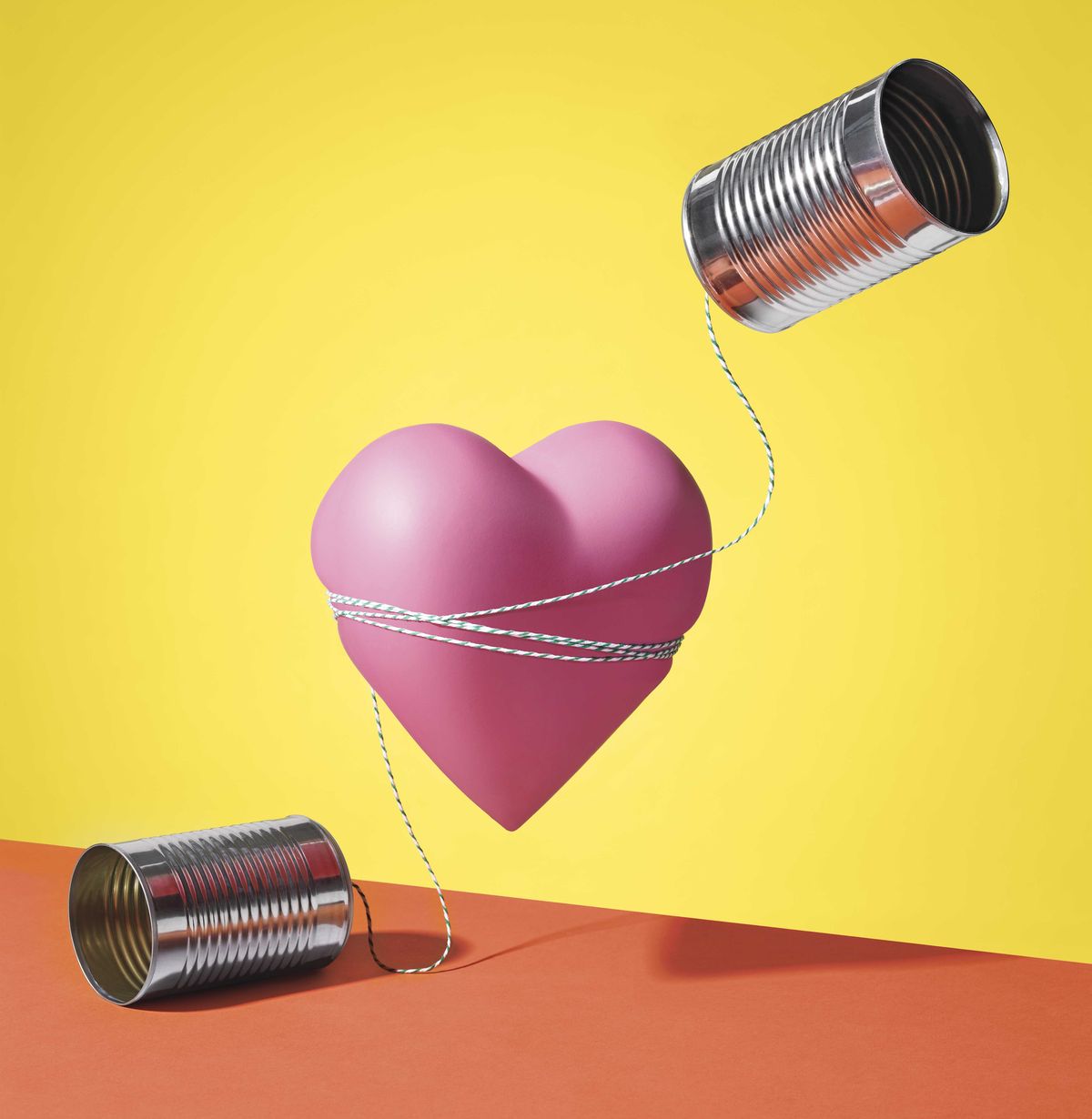 a heart with tin cans attached with string to represent talking about love and sex