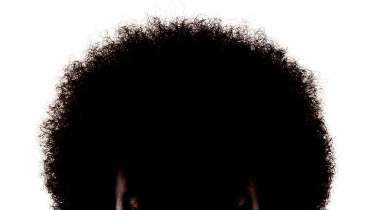 silhouette portrait of african american girl with curly hair afro hairstyle isolated on white background