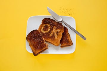 burnt toast with the word ok on a slice