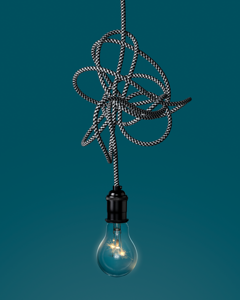light bulb hanging from tangled wire