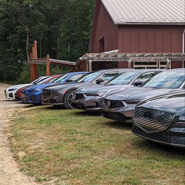 a lineup of luxury cars awaiting car and driver editors' evaluation