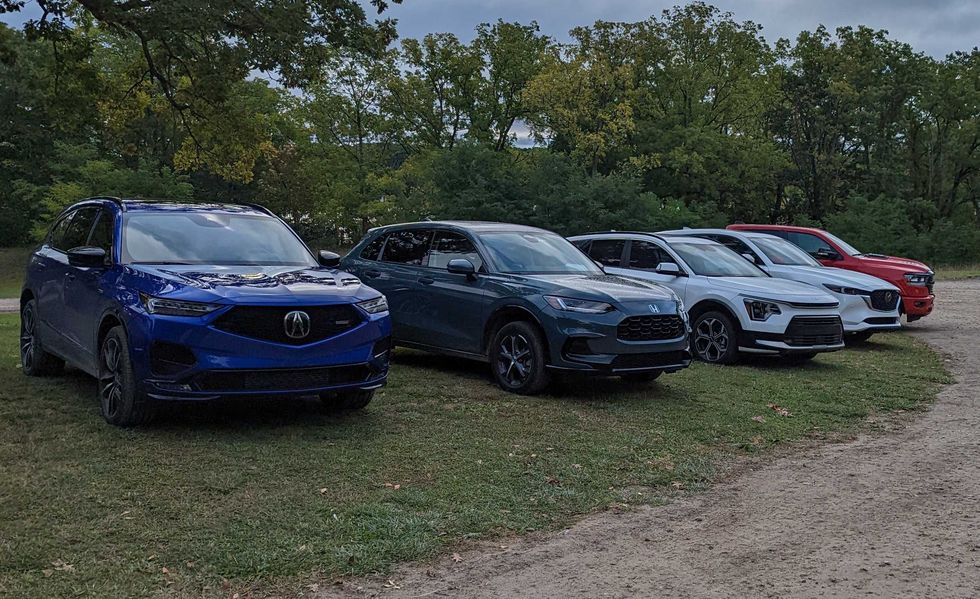 a line of suvs and trucks awaiting car and driver editors' evaluation