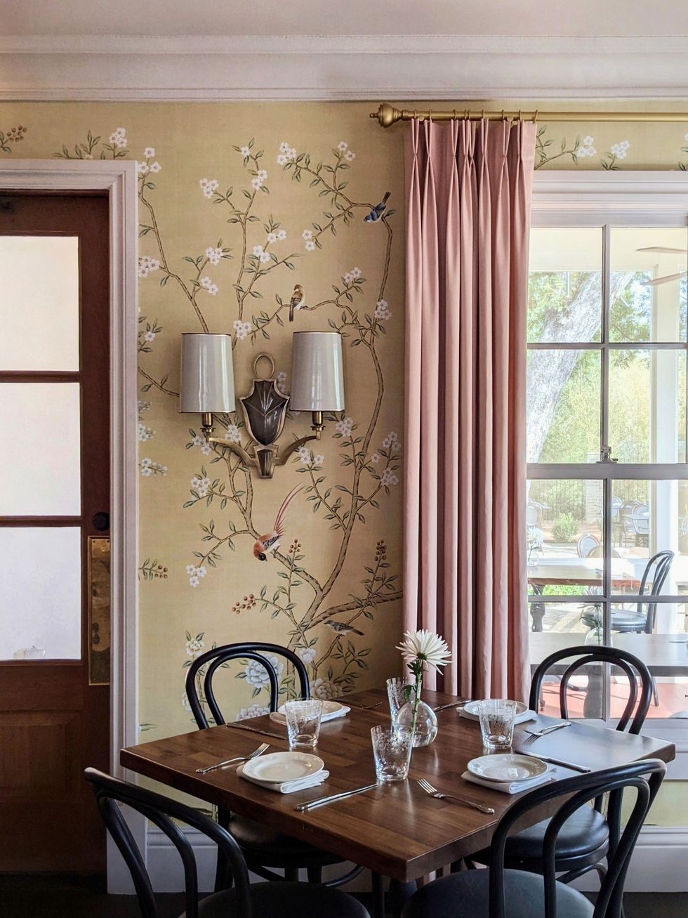 tan floral wallpaper and dining table