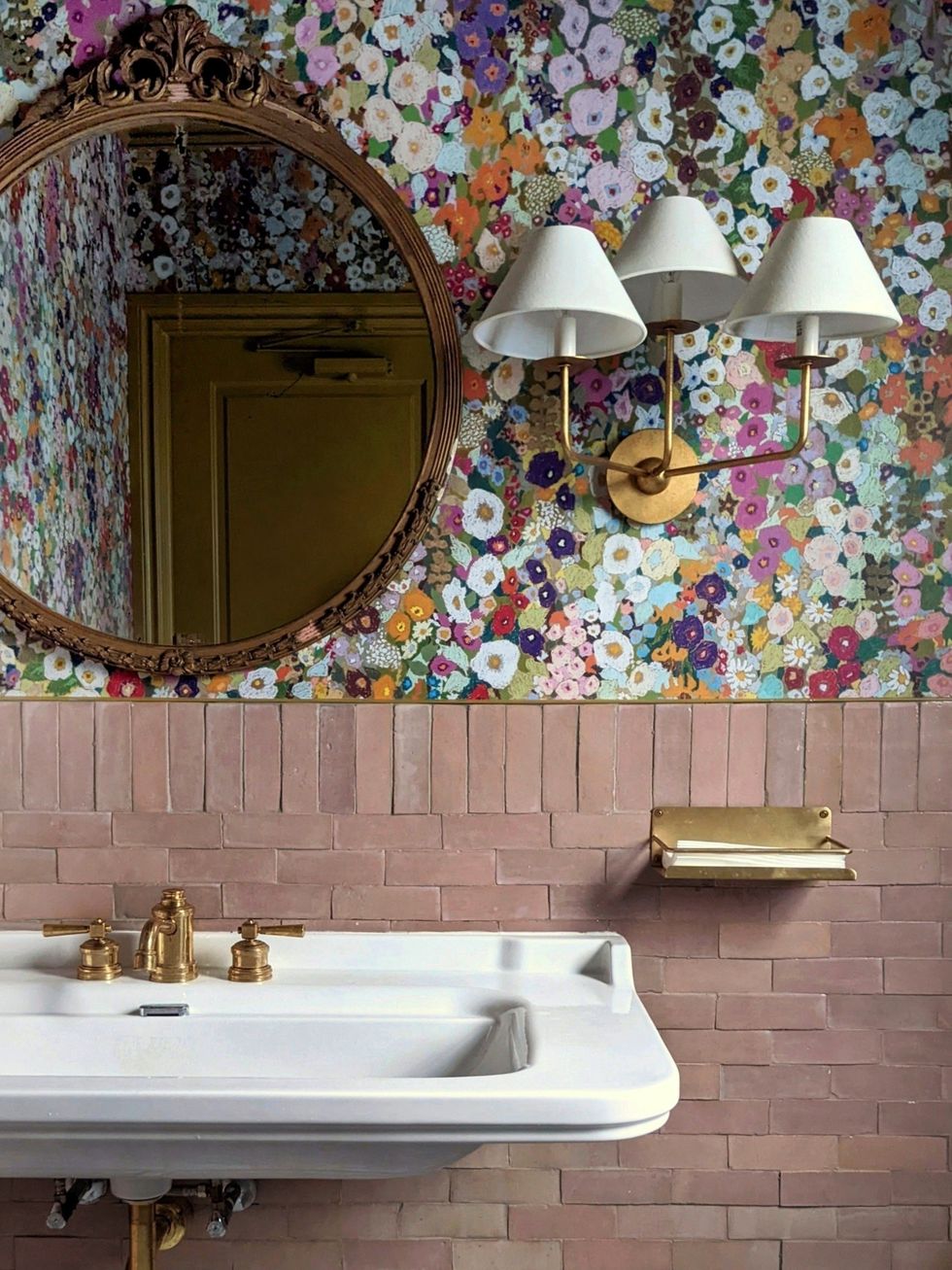 bathroom sink and colorful flowered wallpaper