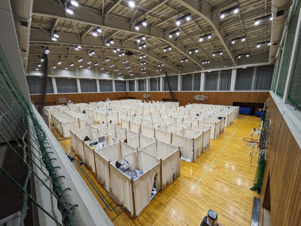 a large room with many wooden shelves