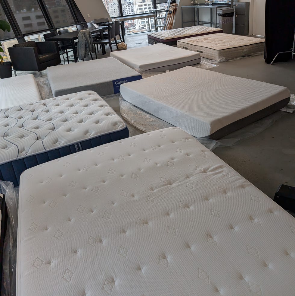 best cooling mattress - testing image a room full of mattresses on the ground, good housekeeping's best cooling mattresses