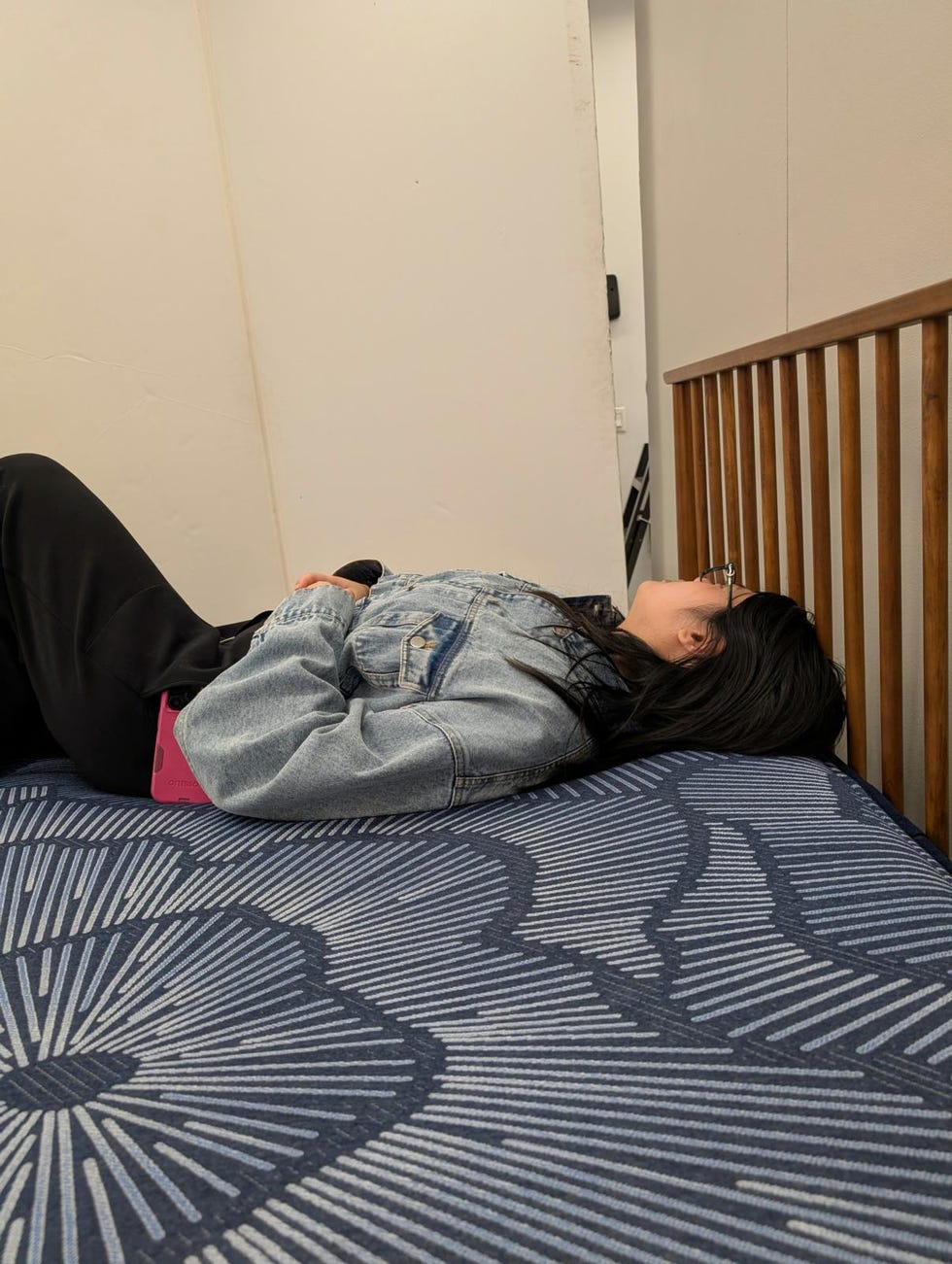 a person lying on their back on a mattress