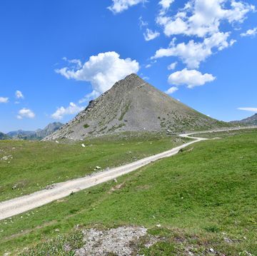 pyramidal peak above grassy plateau