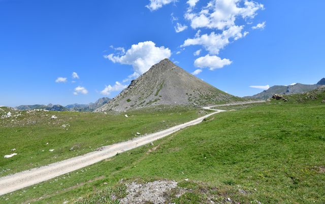 pyramidal peak above grassy plateau