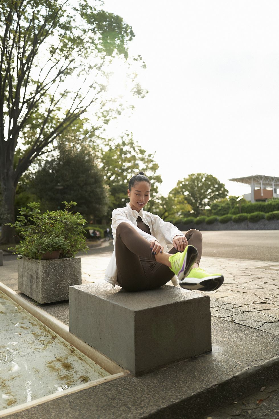 a man sitting on a stone bench