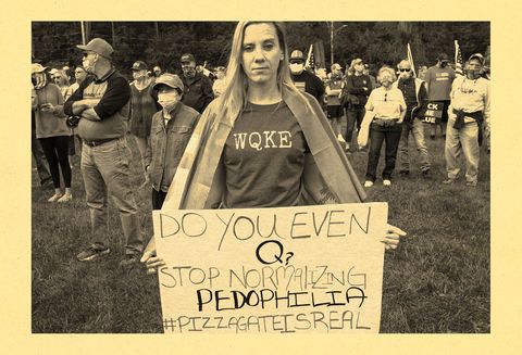 female qanon supporter hold sign that reads "do you even q stop normalizing pedophilia pizzagateisreal"