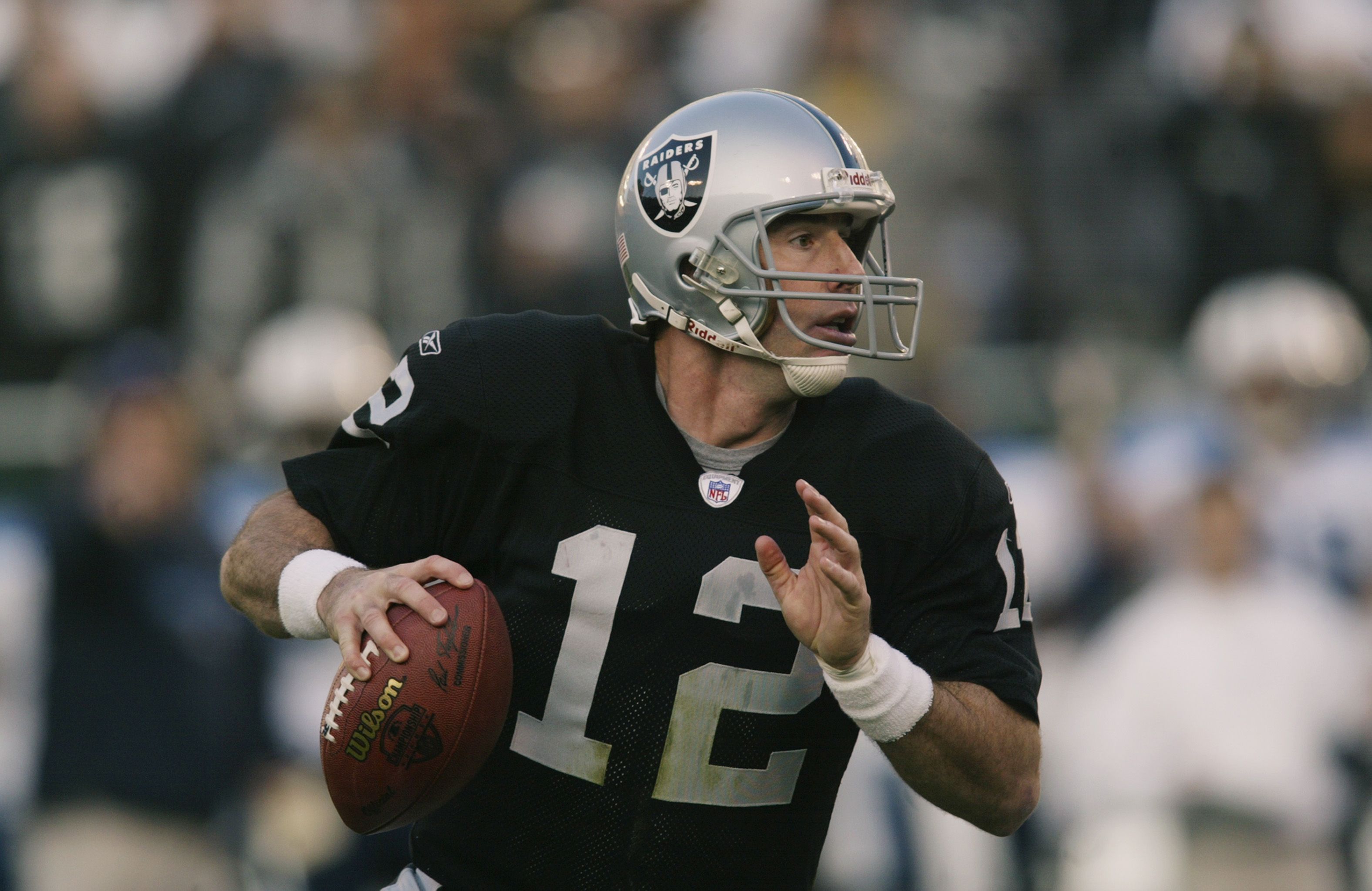 Rich Gannon of the Oakland Raiders adjusts his helmet against the News  Photo - Getty Images