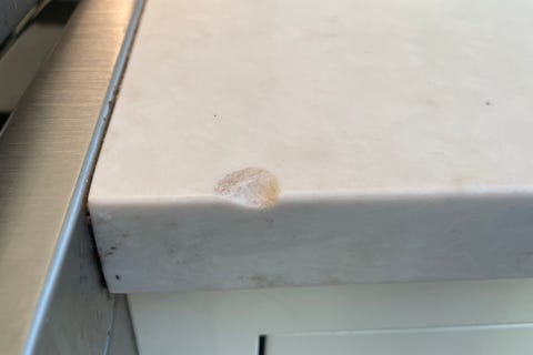 countertop testing a quartz countertop with a chip in its edge, likely caused by a heavy cast iron pan