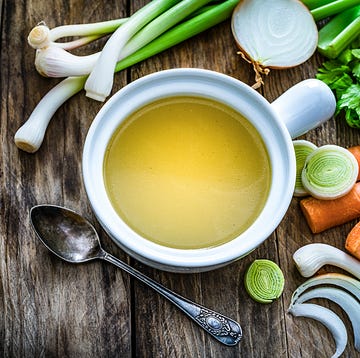 Vegetables broth with ingredients shot on rustic kitchen table. Copy space dieta blanda