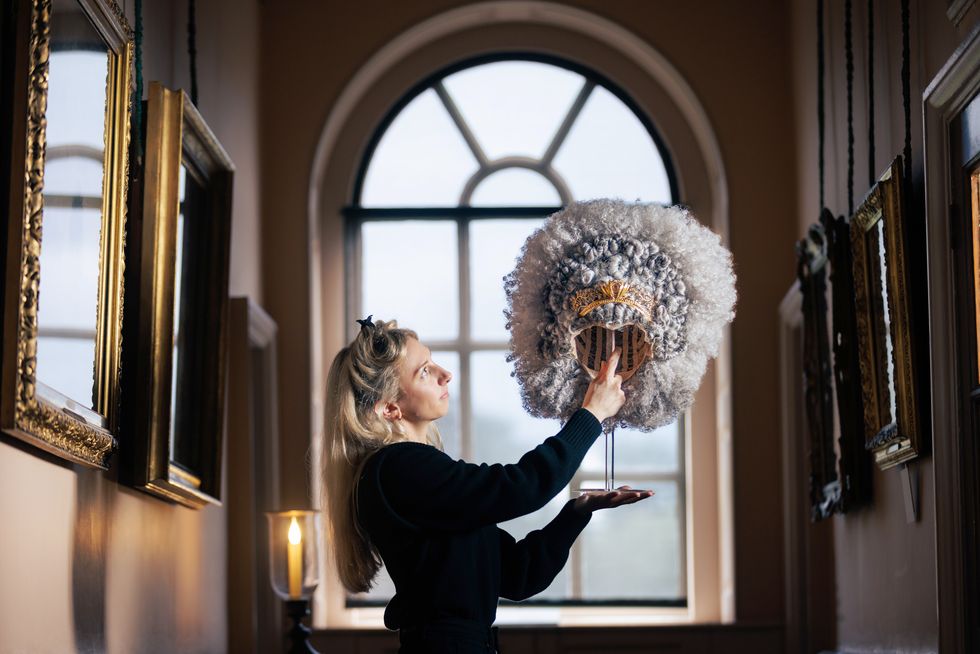 golda rosheuvel' wig from queen charlotte a bridgerton story is on display at kew palace