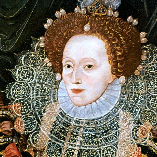 queen elizabeth i wears an ornate collar on her large dress, her hair is adorned with large pearls and other jewelry