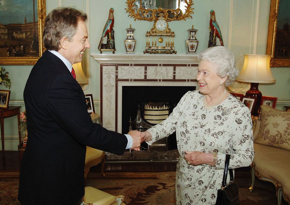 tony blair shakes hands with queen elizabeth ii