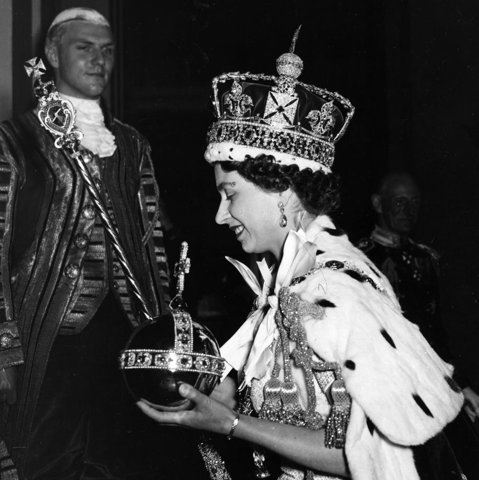queen elizabeth ii wearing the imperial state crown and carrying the orb and sceptre, leaving the state coach and entering buckingham palace, after the coronation original publication picture post 6537 the coronation of queen elizabeth ii pub 1953 photo by hulton archivegetty images