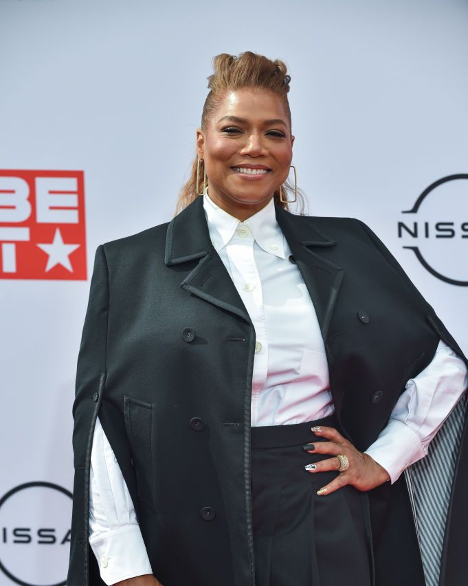 queen latifah wears a white button up shirt and black jacket on the red carpet