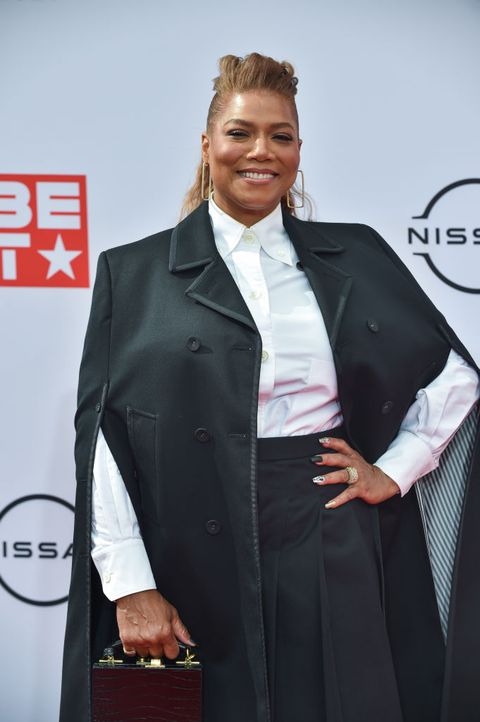 queen latifah wears a white button up shirt and black jacket on the red carpet