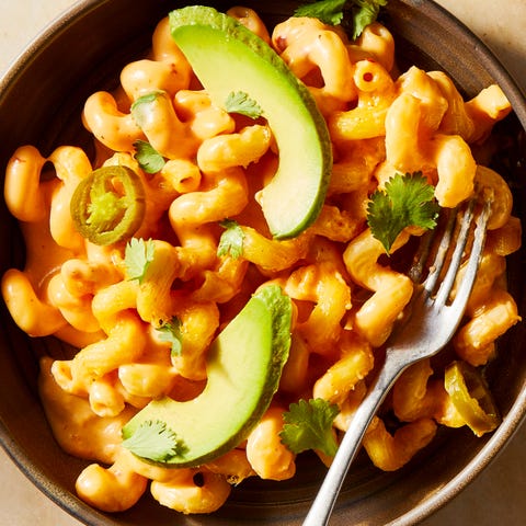 mac and cheese topped with sliced avocado and jalapenos