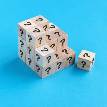 question mark wood cube on blue background