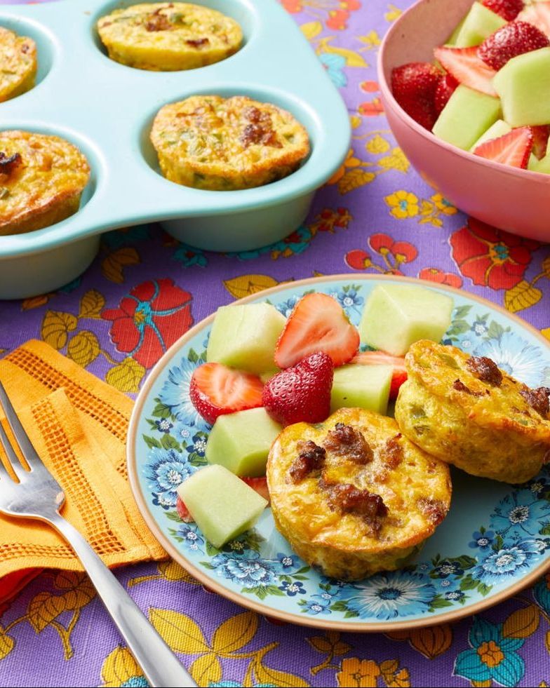 individual sausage casseroles on plate with fruit salad