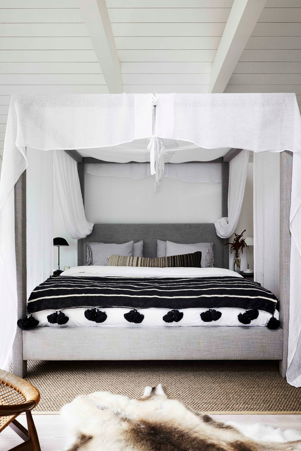 a bed with a white and black striped bed spread
