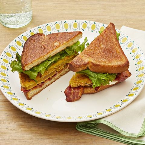 fried green tomato blt on white plate with yellow dots