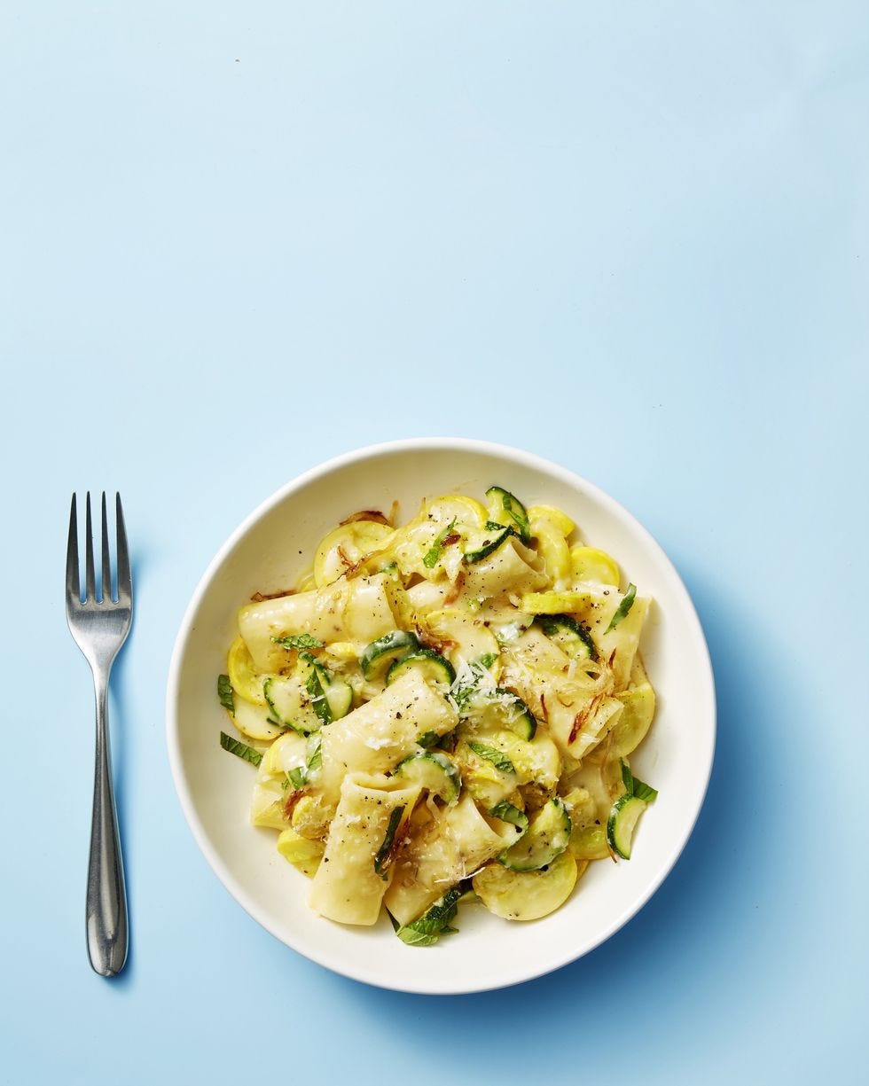 summer squash, mint, and pecorino pasta on a white plate