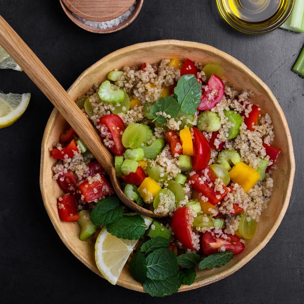 quinoa salad with red and yellow bell peppers tomatoes, celery and grapes