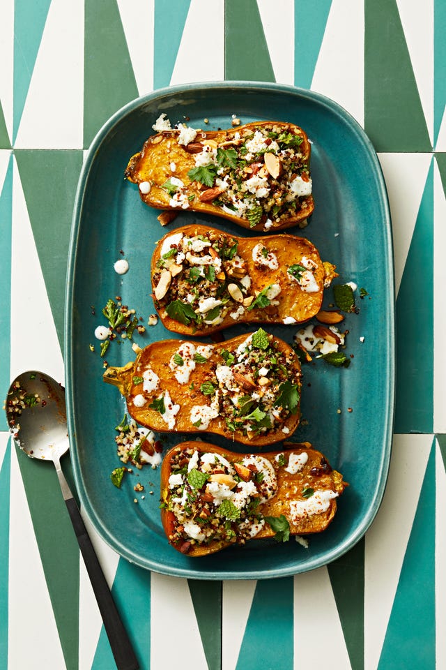 quinoa stuffed honeynut squash on a teal platter