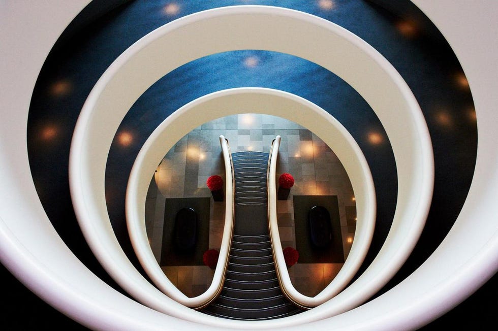 spiral staircase leading down with circular railings and decorative elements