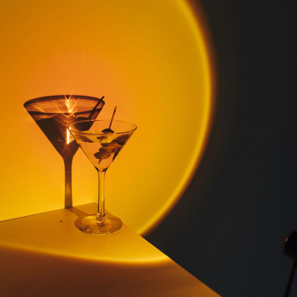 martini glass cocktail on neon orange light at nightclub
