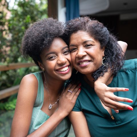 mother and daughter embracing at home