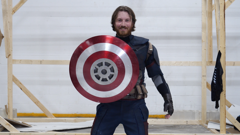 youtube's the hacksmith posing with captain america's shield