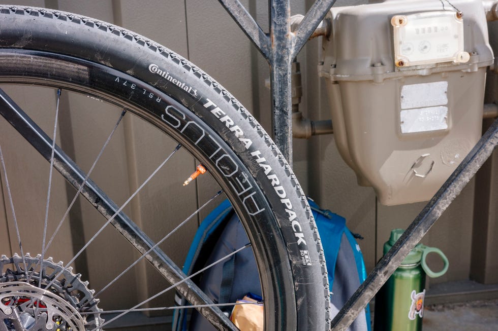 A wall against a wall and backpack near bike tires